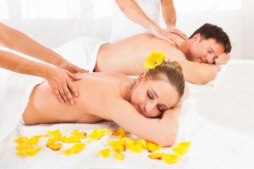 Therapist performing a relaxing back massage in a spa setting