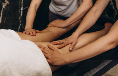 Client relaxing on a massage table in a calm clinic room