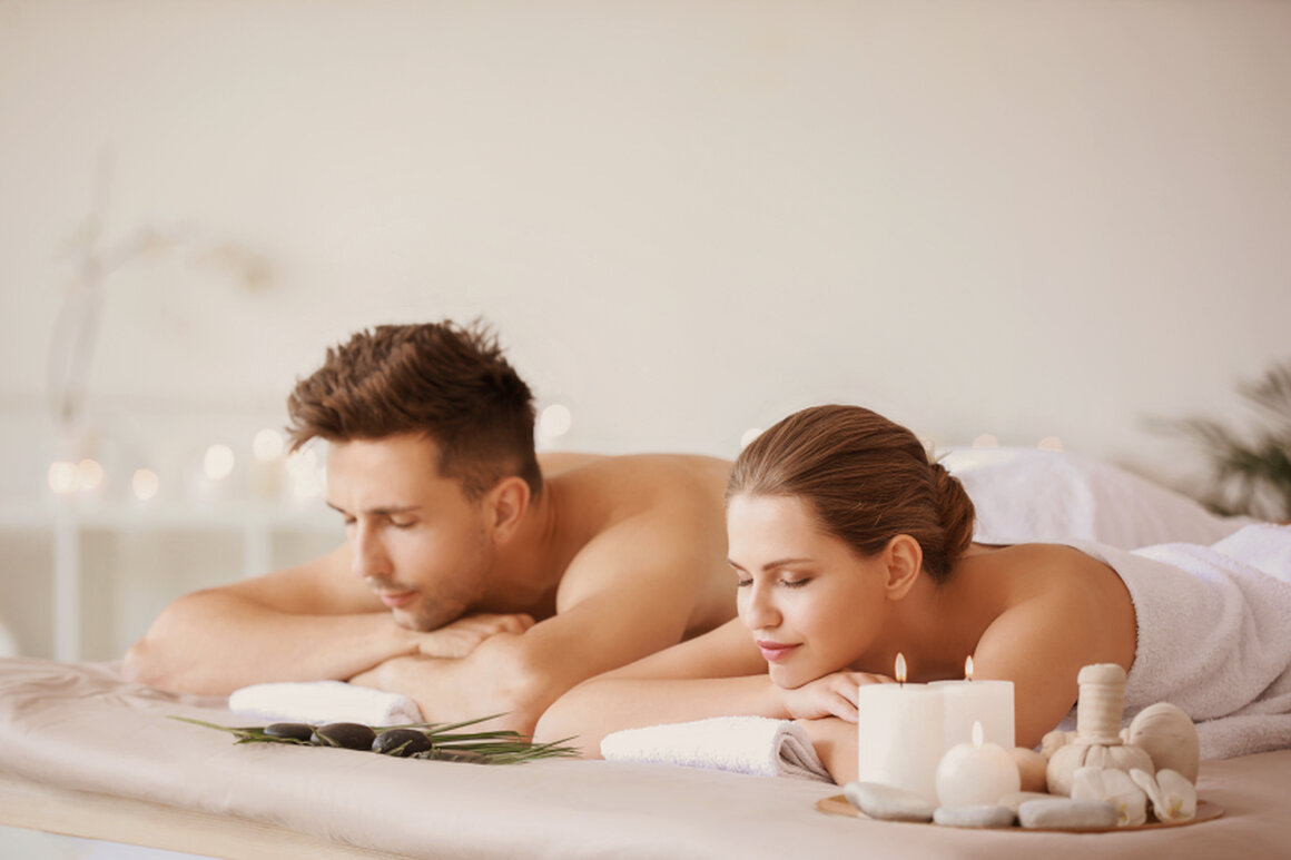 Couple lying side by side receiving a couples massage