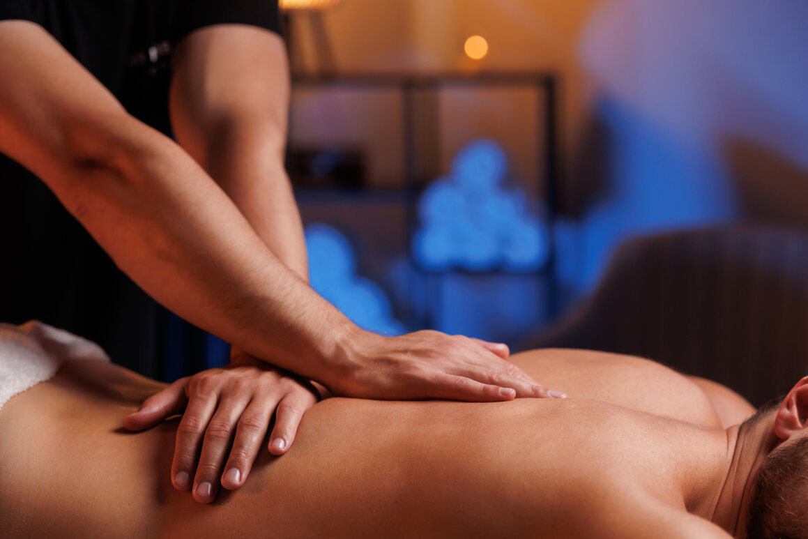 Smooth hot stones placed along the spine during a massage